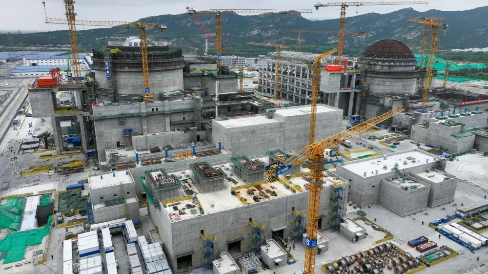 NANJING, June 19, 2024 -- A drone photo shows a construction site of the Tianwan Nuclear Power Station Unit 7 and Unit 8 in Lianyungang, east China's Jiangsu Province, June 19, 2024. Unit 7, as well as Unit 8, has a capacity of 1.265 million kilowatts. And once completed, the two units are estimated to generate about 18.8 billion kilowatt-hours of electricity every year. Started on May 19, 2021, the construction of these two units has gone smoothly.,Image: 882984827, License: Rights-managed, Restrictions:, Model Release: no
