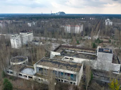 FILE - A dome-shaped shelter covering the damaged reactor at the Chernobyl nuclear plant is seen on the horizon, April 15, 2021, from the abandoned town of Pripyat, Ukraine, once home to some 50,000 people whose lives were connected to the plant. (AP Photo/Efrem Lukatsky, File)