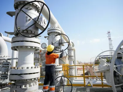 FILE PHOTO: A worker operates valves at the Rumaila oil field, as the country cuts nearly 1.5 million barrels per day of output amid halted exports following the closure of the Strait of Hormuz, in Basra, Iraq, March 4, 2026. REUTERS/Essam Al-Sudani/File Photo