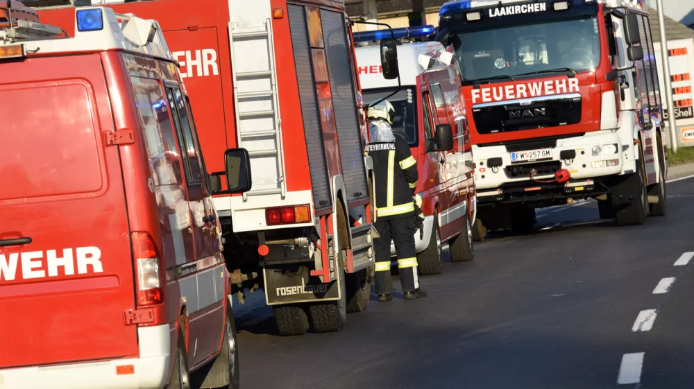 Many fire engines on a street during a large fire-fighting mission in Upper Austria - the fire departments in Austria are largely organized on a voluntary basis - their members come on volunteer missions