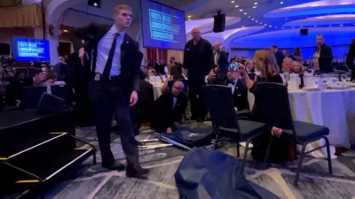 A Secret Service agent unholsters his gun, shortly after U.S. President Donald Trump was evacuated, after a man opened fire with a shotgun on security personnel outside the room during the annual White House Correspondents' Association dinner in Washington, D.C., U.S., April 25, 2026, in this screengrab from a video. REUTERS/Bo Erickson