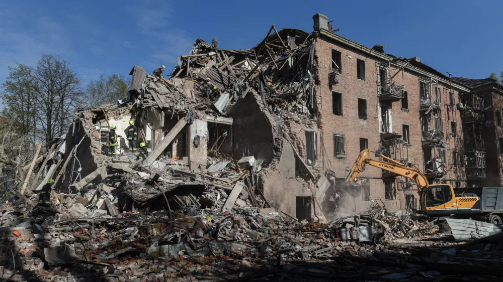 Rescue workers clear the rubble of a residential building destroyed by a Russian strike, in Dnipro, Ukraine, Saturday, April 25, 2026. (AP Photo/Mykola Synelnykov)
