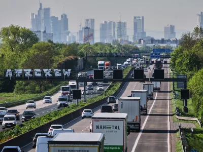 Cars and trucks move on a highway towards Frankfurt, Germany, Friday, April 24, 2026. (AP Photo/Michael Probst)