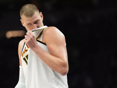 Denver Nuggets center Nikola Jokic (15) waits for play to resume during the second half in Game 3 of a first-round NBA basketball playoff series against the Minnesota Timberwolves, Thursday, April 23, 2026, in Minneapolis. (AP Photo/Abbie Parr)