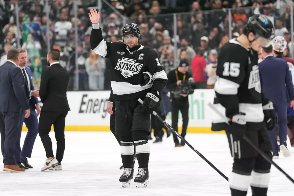 After the final game of his career, Los Angeles Kings' Anze Kopitar, center, waves to the fans following Game 4 in the first round of an NHL hockey Stanley Cup playoff series against the Colorado Avalanche, Sunday, April 26, 2026, in Los Angeles. (AP Photo/Scott Strazzante)