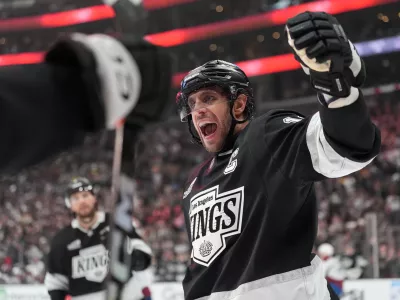 Los Angeles Kings' Anze Kopitar (11) celebrates a goal by Joel Edmundson against the Colorado Avalanche during the second period of Game 4 in the first round of an NHL hockey Stanley Cup playoff series Sunday, April 26, 2026, in Los Angeles. (AP Photo/Scott Strazzante)