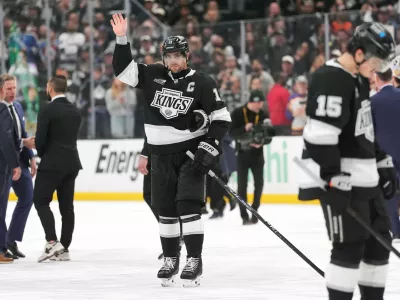 After the final game of his career, Los Angeles Kings' Anze Kopitar, center, waves to the fans following Game 4 in the first round of an NHL hockey Stanley Cup playoff series against the Colorado Avalanche, Sunday, April 26, 2026, in Los Angeles. (AP Photo/Scott Strazzante)