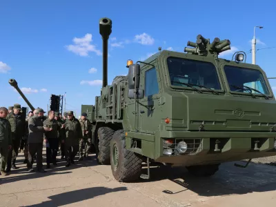 Russian Security Council Deputy Chairman and the head of the United Russia party Dmitry Medvedev looks at advanced weapons during his visit to the Kapustin Yar test range in Astrakhan region, Russia, Saturday, Oct. 18, 2025. (Ekaterina Shtukina, Sputnik, Pool Photo via AP)