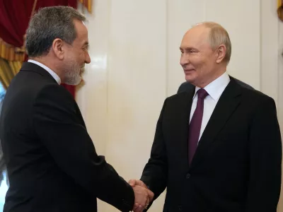 Russian President Vladimir Putin, right, shakes hands with Iranian Foreign Minister Abbas Araghchi during their meeting at the Boris Yeltsin Presidential Library, in St. Petersburg, Russia, Monday, April 27, 2026. (AP Photo/Dmitri Lovetsky, Pool)