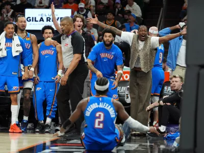 Oklahoma City Thunder guard Shai Gilgeous-Alexander (2) celebrates his score against the Phoenix Suns with teammates on the bench during the second half of Game 4 in a first-round NBA playoffs basketball series, Monday, April 27, 2026, in Phoenix. (AP Photo/Ross D. Franklin)