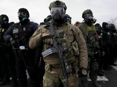 Members of U.S. Customs and Border Protection (CBP) and other law enforcement officials stand guard, in front of the Bishop Henry Whipple Federal Building, during a protest more than a week after an ICE agent fatally shot Renee Nicole Good, in Minneapolis, Minnesota, U.S., January 17, 2026. REUTERS/Seth Herald TPX IMAGES OF THE DAY
