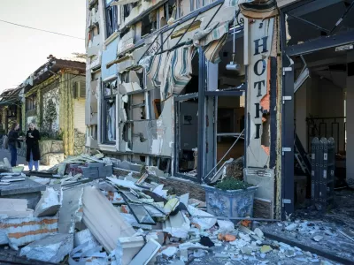 Residents stand at the site a hotel hit by a Russian drone strike, amid Russia's attack on Ukraine, in Odesa, Ukraine April 27, 2026. REUTERS/Nina Liashonok