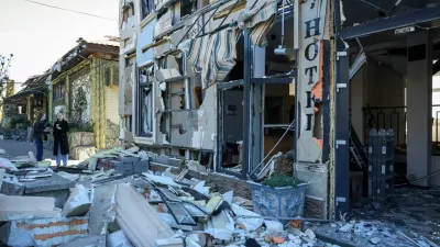 Residents stand at the site a hotel hit by a Russian drone strike, amid Russia's attack on Ukraine, in Odesa, Ukraine April 27, 2026. REUTERS/Nina Liashonok