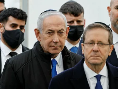 FILE PHOTO: Israeli Prime Minister Benjamin Netanyahu and Israeli President Isaac Herzog attend a memorial service held for Ran Gvili, an off-duty police officer who was killed fighting militants that had infiltrated Israel during the deadly October 7, 2023, attack by Hamas, and the last hostage recovered from Gaza, in Meitar, Israel, January 28, 2026. REUTERS/Amir Cohen/File Photo