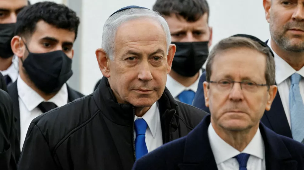 FILE PHOTO: Israeli Prime Minister Benjamin Netanyahu and Israeli President Isaac Herzog attend a memorial service held for Ran Gvili, an off-duty police officer who was killed fighting militants that had infiltrated Israel during the deadly October 7, 2023, attack by Hamas, and the last hostage recovered from Gaza, in Meitar, Israel, January 28, 2026. REUTERS/Amir Cohen/File Photo