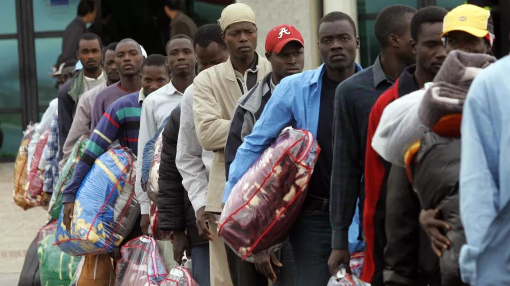 African would-be immigrants wait in line to board a plane to Mali at the airport in Oujda, in northern Morocco, October 13, 2005. Morocco, under pressure to staunch an inrush of immigrants into Spain, flew 139 illegal migrants back to Mali on Wednesday and vowed to continue with the mass deportations despite sharp criticism from the United Nations.REUTERS/Andrea Comas