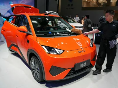 A staff member dusts a BYD Seagull electric vehicle (EV) displayed at the Beijing International Automotive Exhibition, or Auto China, in Beijing, China April 26, 2026. REUTERS/Xiaoyu Yin