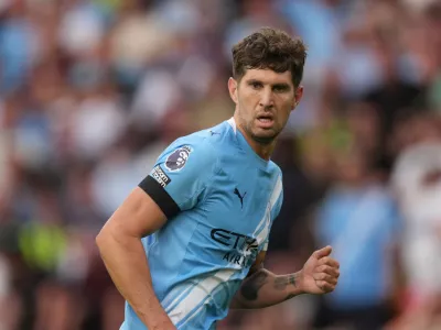 FILE - Manchester City's John Stones runs on the pitch during the English Premier League soccer match between Wolverhampton Wanderers and Manchester City at Molineux Stadium, Wolverhampton, England, Saturday, Aug. 16, 2025. (AP Photo/Dave Shopland, file)