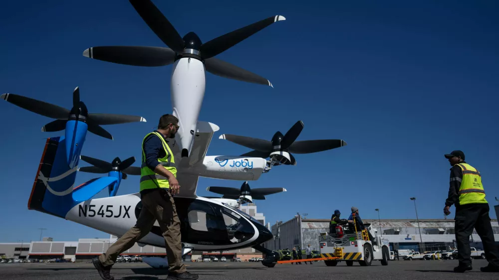 Airport employees move an electric vertical take-off and landing (eVTOL) aircraft by Joby Aviation at the John F. Kennedy International Airport, Monday, April 27, 2026, in New York. (AP Photo/Yuki Iwamura)