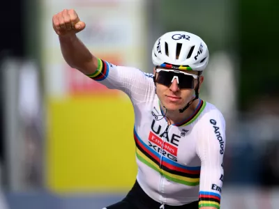 Tadej Pogacar from Slovenia raises his arms after crossing the finish line to win the first stage, a 170,6 km race around Martigny, at the 79th Tour de Romandie cycling race, in Saint-Maurice, Switzerland, Wednesday, April 29, 2026. (Laurent Gillieron/Keystone via AP)