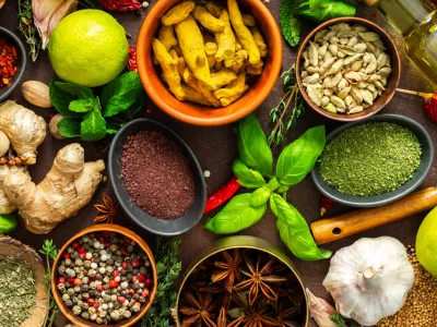 A visually striking arrangement of fresh spices and herbs on a brown surface, highlighting their vivid colors, intricate details and rich culinary essence, banner / Foto: Pundapanda