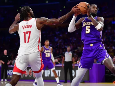 Apr 29, 2026; Los Angeles, California, USA; Houston Rockets forward Tari Eason (17) plays for the ball against Los Angeles Lakers center Deandre Ayton (5) during the first half in game five of the first round of the 2026 NBA Playoffs at Crypto.com Arena. Mandatory Credit: Gary A. Vasquez-Imagn Images