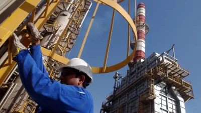 FILE - An oil technician climbs down a tower at a refinery in Jebel Ali, United Arab Emirates, about 30 kilometers (18 miles) south of Dubai, in March 2004. (AP Photo/Kamran Jebreili, File)