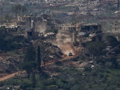 An Israeli military vehicle drives past destroyed buildings in Lebanon, as seen from the Israeli side of the Israel-Lebanon border, April 30, 2026. REUTERS/Shir Torem   TPX IMAGES OF THE DAY