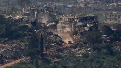 An Israeli military vehicle drives past destroyed buildings in Lebanon, as seen from the Israeli side of the Israel-Lebanon border, April 30, 2026. REUTERS/Shir Torem   TPX IMAGES OF THE DAY