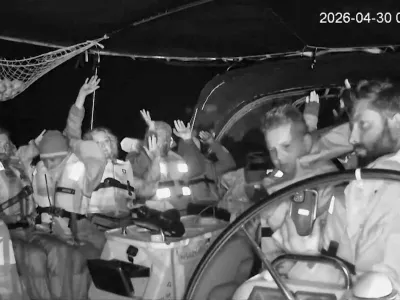 Attention Editors: This image has been cropped by Reuters to enhance quality, and an uncropped version has been provided separately. CCTV footage shows crew members of the second flotilla that sailed from the Spanish port of Barcelona, carrying humanitarian aid to Palestinians in Gaza, raise their arms as the vessel is said to be intercepted by the Israeli Army, at a location given as at sea off the coast of Greece, April 30, 2026, in this screengrab taken from a handout video. Global Sumud Flotilla/Handout via REUTERS  THIS IMAGE HAS BEEN SUPPLIED BY A THIRD PARTY. NO RESALES. NO ARCHIVES. MANDATORY CREDIT. TIME STAMP FROM SOURCE.  VERIFICATION - Location not verified but Global Sumud Flotilla's vessel tracker website shows vessels were intercepted at sea offcoast Greece Date confirmed from the timestamp of the CCTV footage Israel has begun taking control of aid ships bound for Gaza far from Israeli shores, Israeli army radio cited an Israeli source as saying on Wednesday Global Sumud Flotilla confirmed in a statement that their vessels were intercepted by Israeli forces on Wednesday