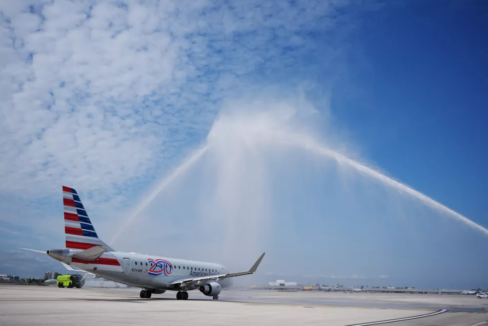 American Airlines Flight AA3599, the first direct commercial flight between the United States and Venezuela in seven years, gets a water cannon salute as it taxis away from the gate, Thursday, April 30, 2026, at Miami International Airport in Miami. (AP Photo/Rebecca Blackwell)