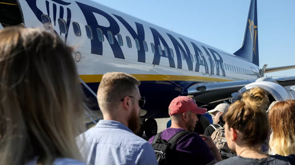 FILE PHOTO: Passengers board a Ryanair flight at the airport in Gdansk, Poland, June 19, 2019. REUTERS/Kevin Coombs/File Photo