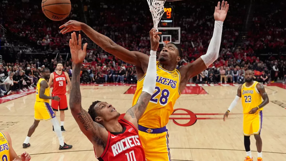 Los Angeles Lakers forward Rui Hachimura (28) blocks a shot by Houston Rockets forward Jabari Smith Jr. (10) during the first half of Game 6 of a first-round NBA playoffs basketball series in Houston, Friday, May 1, 2026. (AP Photo/Ashley Landis)