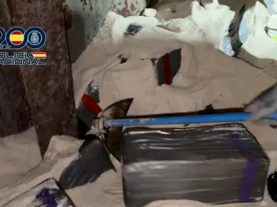 A police officer digs in the salt and uncovers bales of cocaine in a cargo vessel, in Tenerife, Canary Islands, Spain January 12, 2026 in this screengrab obtained from a video. Spanish Police/ via Reuters TV/Handout via REUTERS  THIS IMAGE HAS BEEN SUPPLIED BY A THIRD PARTY. MUST NOT OBSCURE LOGO.