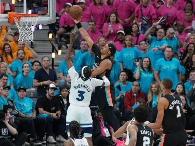 May 4, 2026; San Antonio, Texas, USA; San Antonio Spurs forward Keldon Johnson (3) shoots over Minnesota Timberwolves forward Jaden McDaniels (3) in the second half during game one of the second round of the 2026 NBA Playoffs at Frost Bank Center. Mandatory Credit: Daniel Dunn-Imagn Images