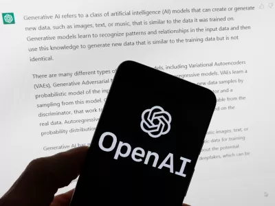 FILE - The OpenAI logo is displayed on a mobile phone in front of a computer screen with output from ChatGPT, March 21, 2023, in Boston. (AP Photo/Michael Dwyer, File)