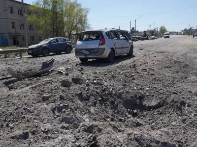 A crater is seen in a residential neighbourhood following a Russian missile attack in Merefa, Kharkiv region, Ukraine, Monday, May 4, 2026. (AP Photo/Andrii Marienko)