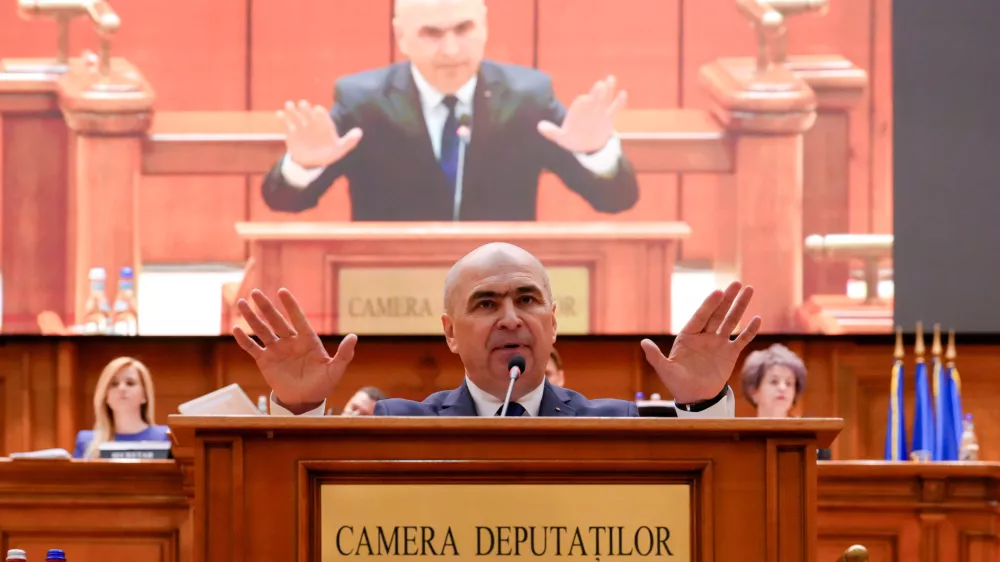 Romanian Prime Minister Ilie Bolojan addresses a parliament session ahead of a no confidence vote in Bucharest, Romania, Tuesday, May 5, 2026. (AP Photo/Vadim Ghirda)