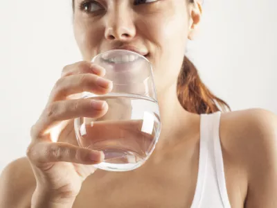 Young woman drinking glass of water