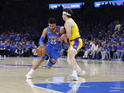 May 5, 2026; Oklahoma City, Oklahoma, USA; Oklahoma City Thunder guard Ajay Mitchell (25) dribbles around Los Angeles Lakers guard Austin Reaves (15) in the second half during game one of the second round of the 2026 NBA Playoffs at Paycom Center. Mandatory Credit: Alonzo Adams-Imagn Images