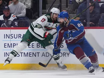 Colorado Avalanche defenseman Brent Burns, right, avoids a check from Minnesota Wild left wing Marcus Foligno in the second period of Game 2 of an NHL hockey Stanley Cup second-round playoff series Tuesday, May 5, 2026, in Denver. (AP Photo/David Zalubowski)