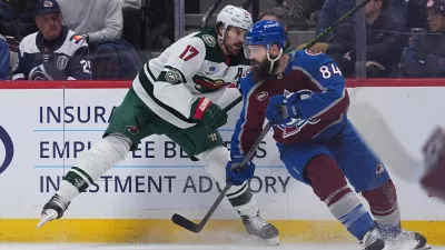 Colorado Avalanche defenseman Brent Burns, right, avoids a check from Minnesota Wild left wing Marcus Foligno in the second period of Game 2 of an NHL hockey Stanley Cup second-round playoff series Tuesday, May 5, 2026, in Denver. (AP Photo/David Zalubowski)