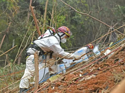 Preiskovalci med delom po nesreči na težko dostopnem območju. / Foto: Profimedia