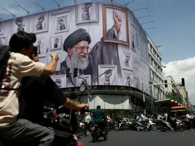 People ride motorcycles near a billboard featuring an image of the late Supreme Leader of Iran, Ayatollah Ali Khamenei, in Tehran, Iran, May 6, 2026. Majid Asgaripour/WANA (West Asia News Agency) via REUTERS ATTENTION EDITORS - THIS PICTURE WAS PROVIDED BY A THIRD PARTY   TPX IMAGES OF THE DAY