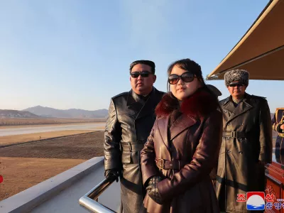This picture taken on November 30, 2023 and released from North Korea's official Korean Central News Agency (KCNA) via KNS on December 1, 2023 shows North Korea's leader Kim Jong Un (L) and his daughter (C), presumed to be named Ju Ae, observing an air festival during a visit with the 1st Air Force Division Flying Regiment of the Korean People's Army to commemorate Air Day, at an unknown location.,Image: 825710791, License: Rights-managed, Restrictions: South Korea OUT / REPUBLIC OF KOREA OUT---EDITORS NOTE--- RESTRICTED TO EDITORIAL USE - MANDATORY CREDIT "AFP PHOTO/KCNA VIA KNS" - NO MARKETING NO ADVERTISING CAMPAIGNS - DISTRIBUTED AS A SERVICE TO CLIENTS / THIS PICTURE WAS MADE AVAILABLE BY A THIRD PARTY. AFP CAN NOT INDEPENDENTLY VERIFY THE AUTHENTICITY, LOCATION, DATE AND CONTENT OF THIS IMAGE ---, ***HANDOUT image or SOCIAL MEDIA IMAGE or FILMSTILL for EDITORIAL USE ONLY! * Please note: Fees charged by Profimedia are for the Profimedia's services only, and do not, nor are they intended to, convey to the user any ownership of Copyright or License in the material. Profimedia does not claim any ownership including but not limited to Copyright or License in the attached material. By publishing this material you (the user) expressly agree to indemnify and to hold Profimedia and its directors, shareholders and employees harmless from any loss, claims, damages, demands, expenses (including legal fees), or any causes of action or allegation against Profimedia arising out of or connected in any way with publication of the material. Profimedia does not claim any copyright or license in the attached materials. Any downloading fees charged by Profimedia are for Profimedia's services only. * Handling Fee Only ***, Model Release: no