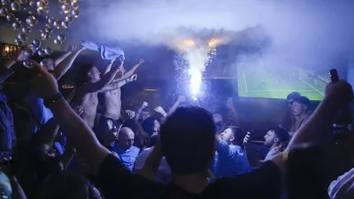Manchester City fans react watching the Champions League final soccer match between Manchester City and Inter Milan in coffee shop in Istiklal street, Istanbul, Turkey, Saturday, June 10, 2023. (AP Photo/Khalil Hamra)