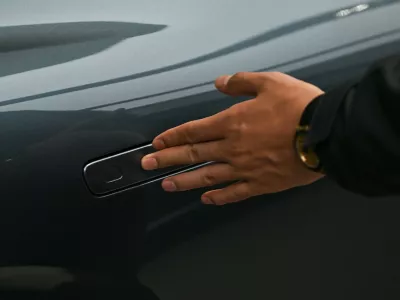 A man opens the door for a Zeekr X7 electric vehicle at a showroom in Beijing on February 3, 2026. China will ban hidden door handles on cars sold in the country from next year, phasing out the minimalist design popularised by Tesla over safety concerns.,Image: 1071617304, License: Rights-managed, Restrictions:, Model Release: no