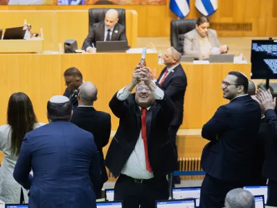 Israel's Minister of National Security, Itamar Ben-Gvir, center, and lawmakers celebrate after Israel's parliament passed a law approving the death penalty for Palestinians convicted of murdering Israelis, at the Knesset in Jerusalem Monday, March 30, 2026. (AP Photo/Itay Cohen)