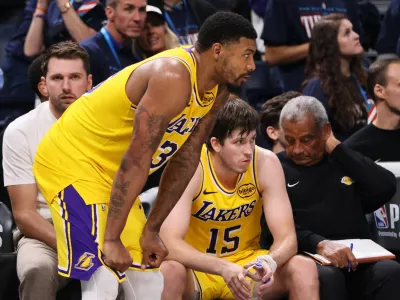 Los Angeles Lakers' Marcus Smart, center, Luka Doncic, left rear, and Austin Reaves (15) sit on the bench watching play late in the second half of Game 2 in a second-round NBA basketball playoffs series against the Oklahoma City Thunder Thursday, May 7, 2026, in Oklahoma City. (AP Photo/Nate Billings)