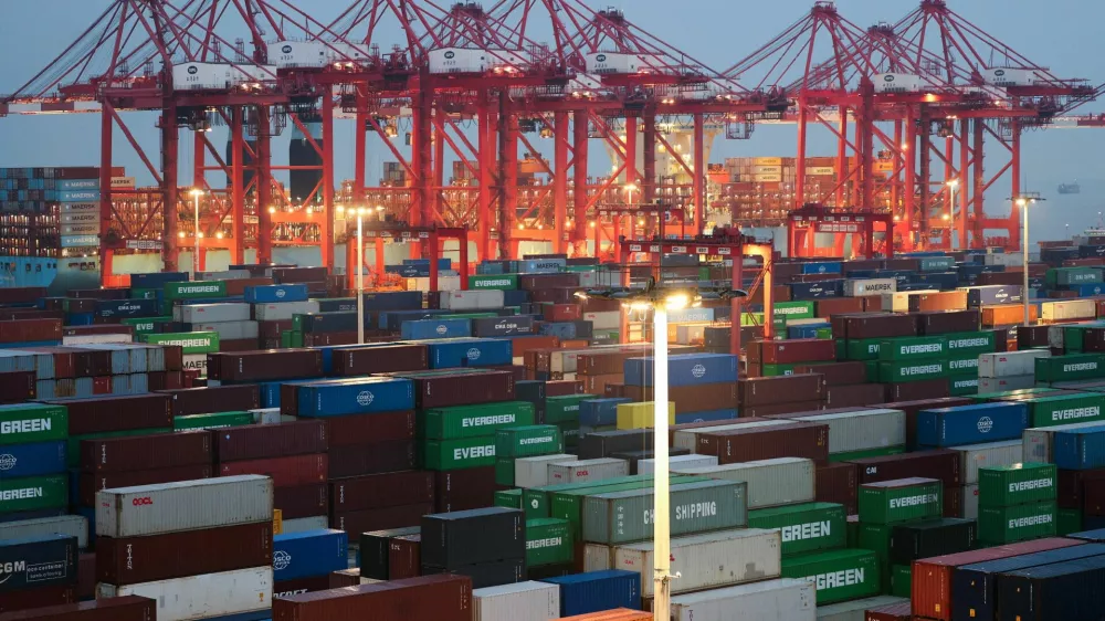 Gantry cranes stand near stacked shipping containers at Yangshan Port outside Shanghai, China, May 7, 2026. REUTERS/Go Nakamura